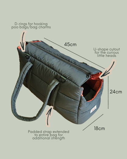 Dark olive green puffer pet carrier with comfortable padded orange interior and U-cut side opening for pets and long shoulder strap for strength and comfort