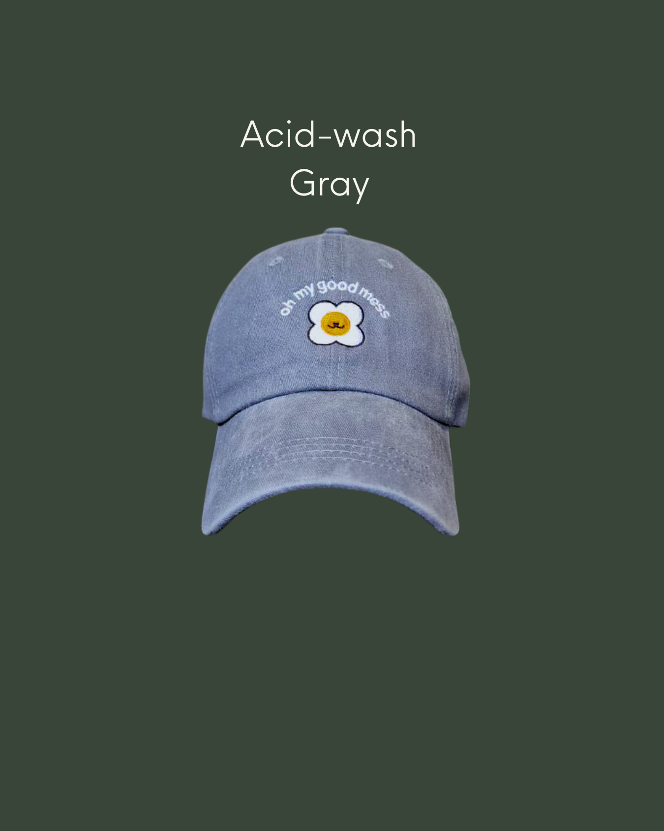 Man wearing an acid wash cap in grey gray with Good Mess motif logo
