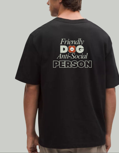 Person wearing a black tee shirt with text 'Friendly Dog Anti-Social Person' on the back. 100% cotton 210gsm.