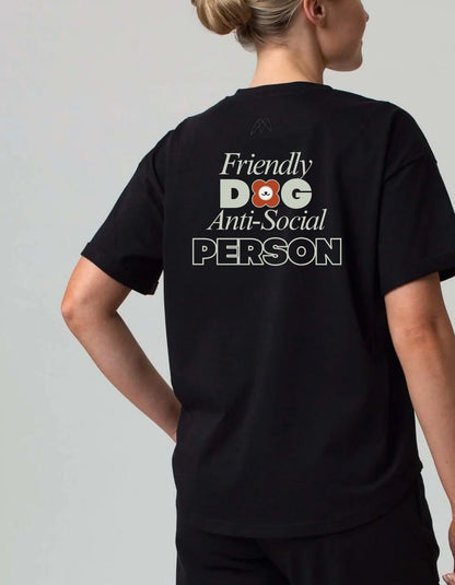 Person wearing a black tee shirt with text 'Friendly Dog Anti-Social Person' on the back. 100% cotton 210gsm.
