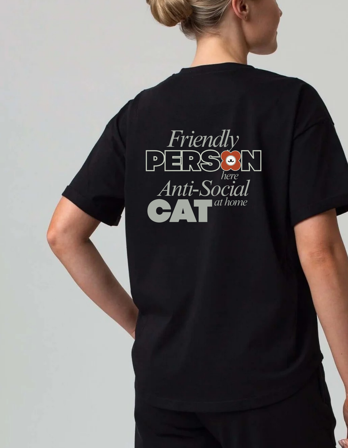 Person wearing a black tee shirt with text 'Friendly person Anti-Social cat' on the back. 100% cotton 210gsm.