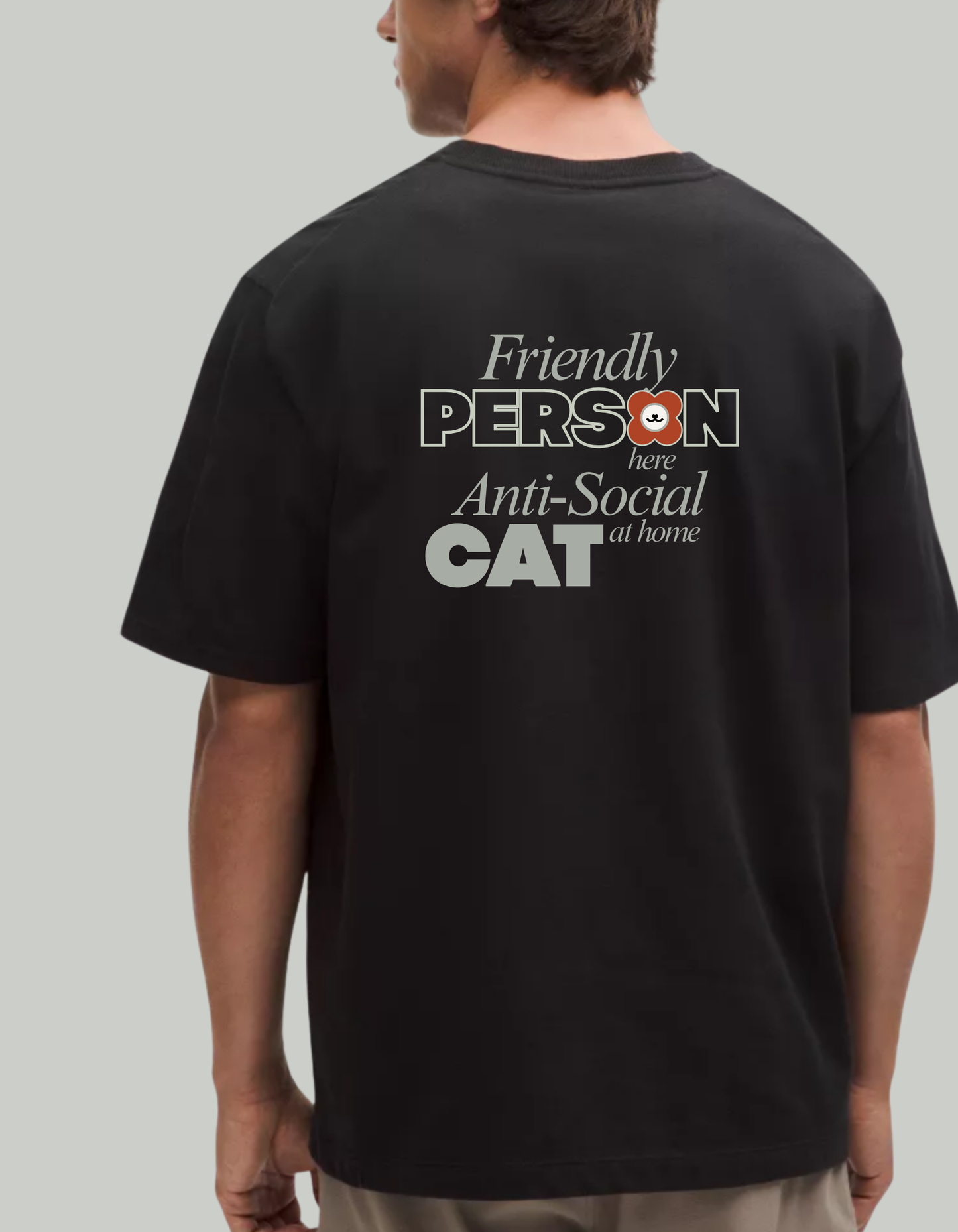 Person wearing a black tee shirt with text 'Friendly person Anti-Social cat' on the back. 100% cotton 210gsm.