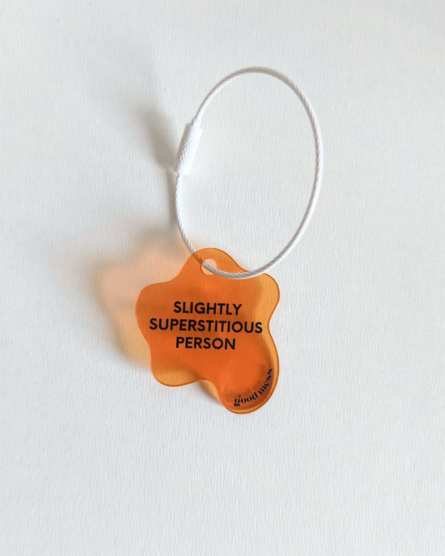 twinning orange acrylic bag charm "Slightly superstitious" for hooman with matching pet collar charm "Rib belly for good luck" for cats and dogs