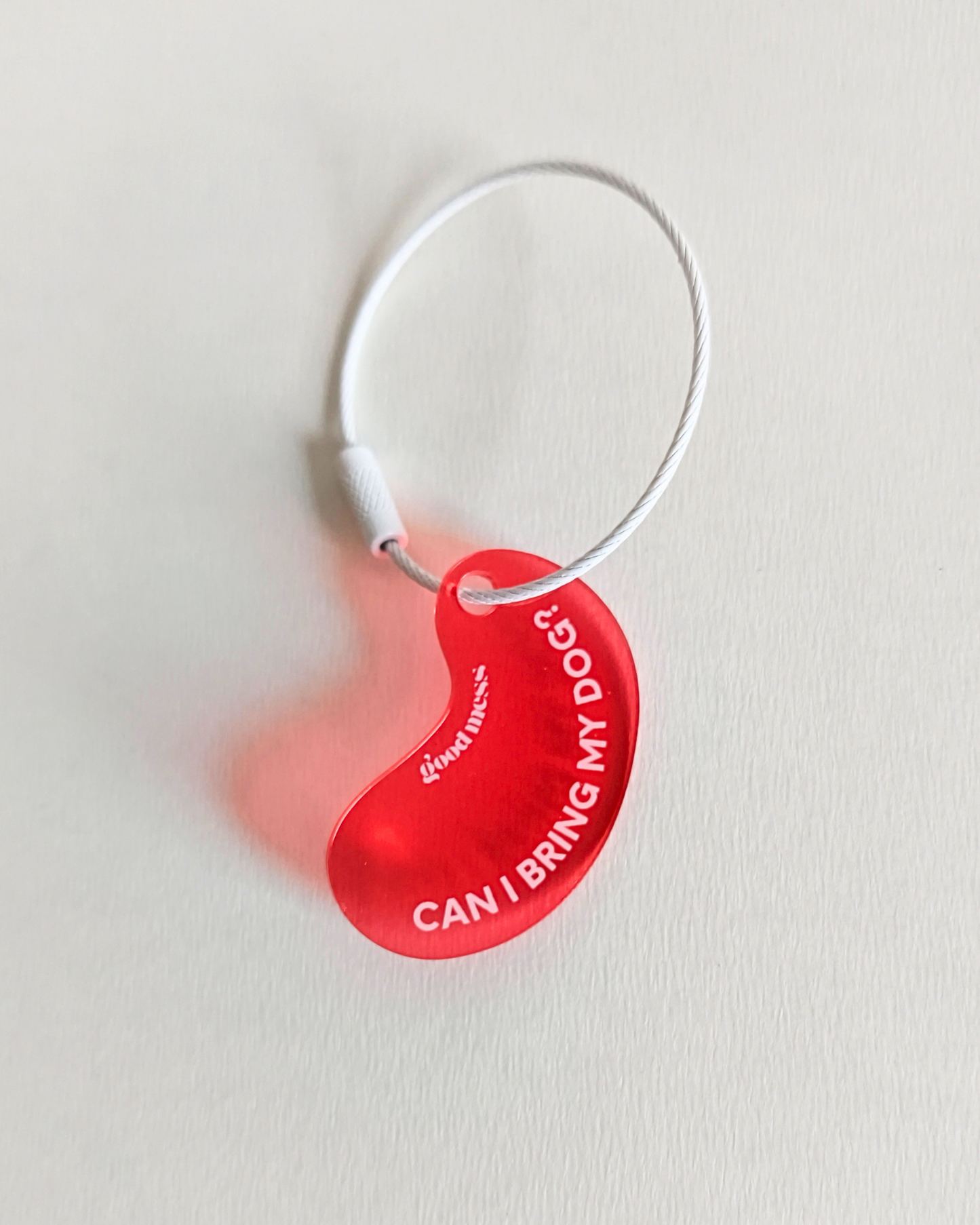 Twinning red acylic bean-shaped bag  charm with funny text "Can I bring my dog?" by Good Mess. For cats and dogs.