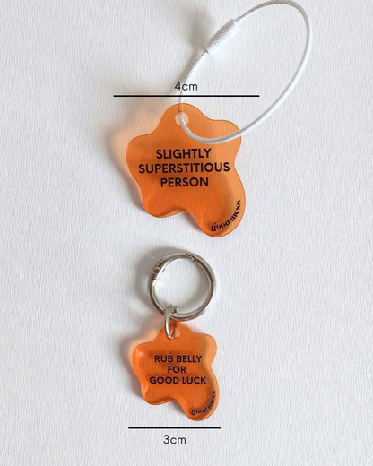 orange acrylic matching pet collar charm with twinning witty quotes  "Rib belly for good luck" and bag charm "Slightly superstitious"
